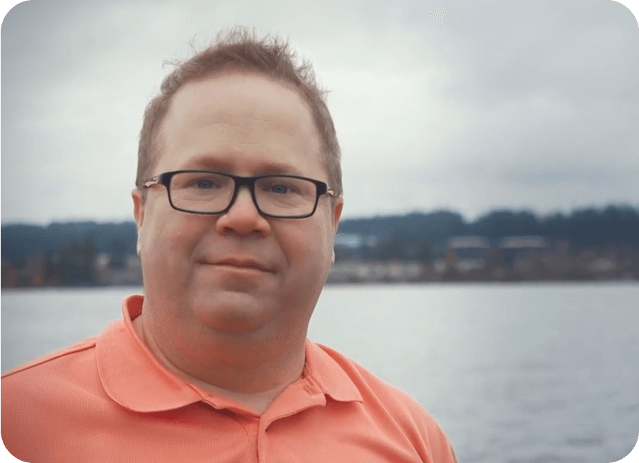 Omnipod Podder David S. standing in front of a body of water