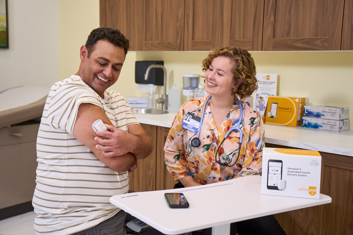 HCP nurse with patient in office as patient is holding onto Omnipod Pod on his right arm