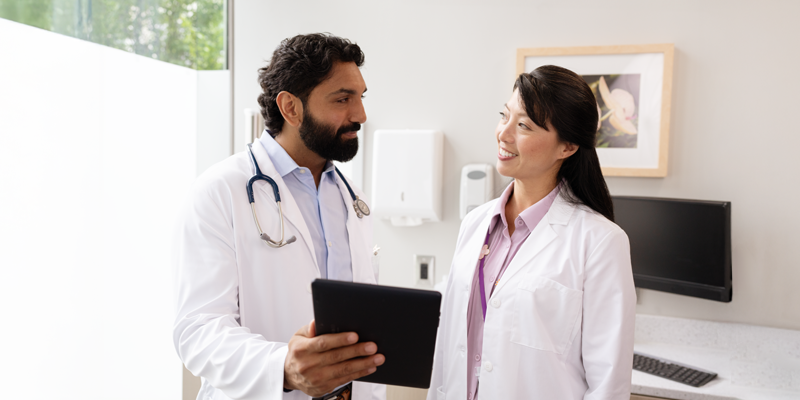 doctors talking with tablet